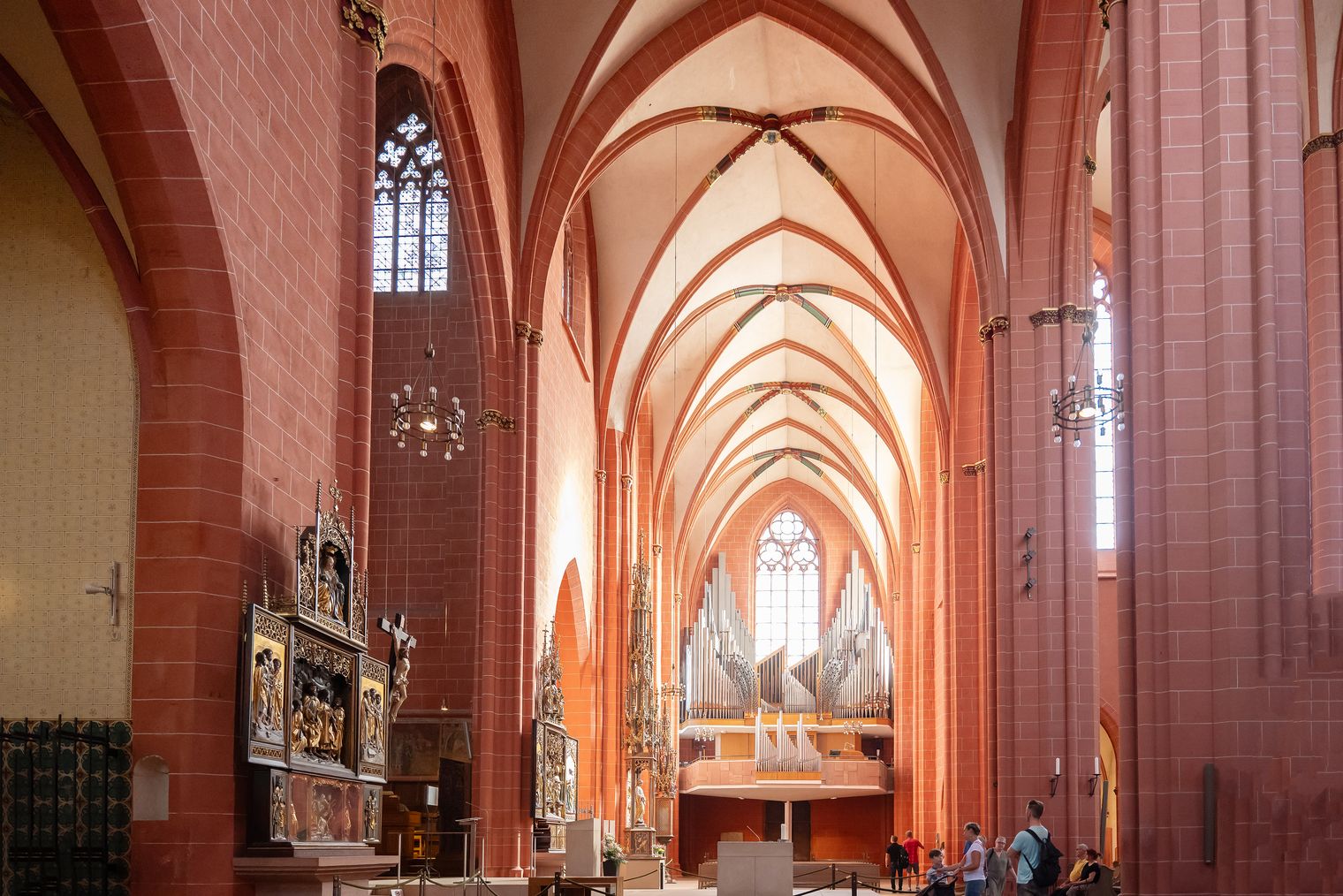Innenraum einer gotischen Kirche mit Orgel und Besuchern in Frankfurt